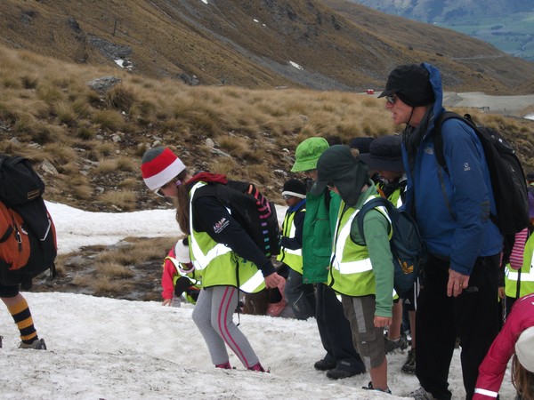 Peter Hillary on the snow at The Remarkables with pupils from the school